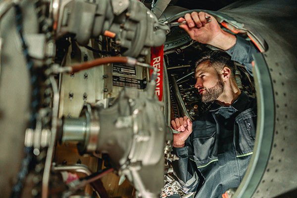 Mechanic repairing plane